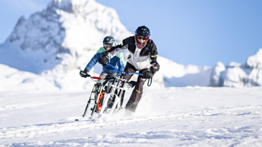 Two Men Riding Bikes in Snow in Annecy City 
